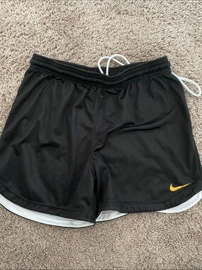 Nike Women’s Black Athletic Shorts with Yellow Swoosh Accent